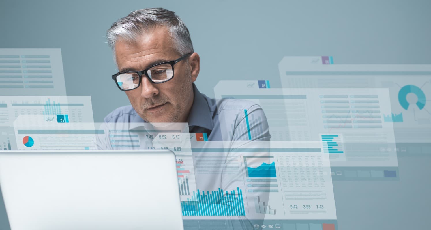 An executive examining connected business and technology evidence