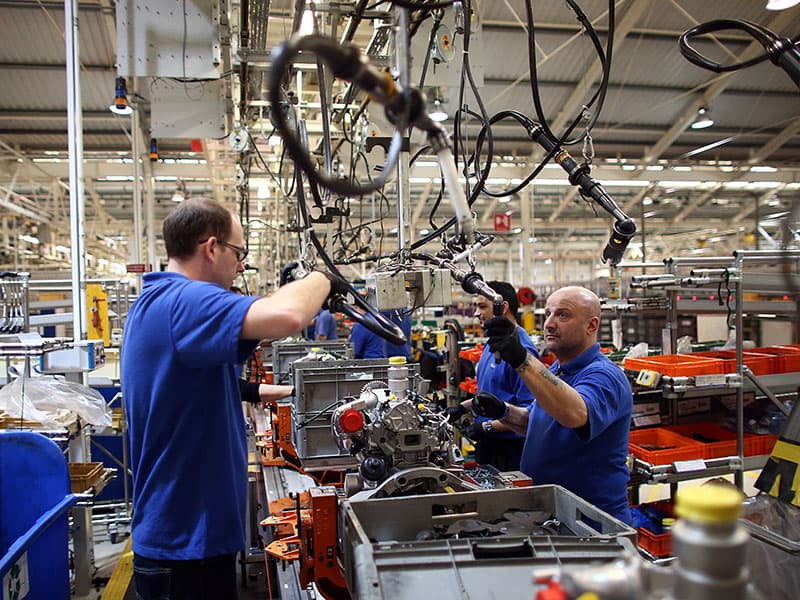 Engineers working on a precision manufacturing production line
